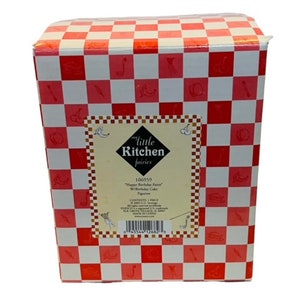 May include: A red and white checkered box with a label that reads "My Little Kitchen Fairies" and "106959 "Happy Birthday Fairy" W/Birthday Cake Figure".