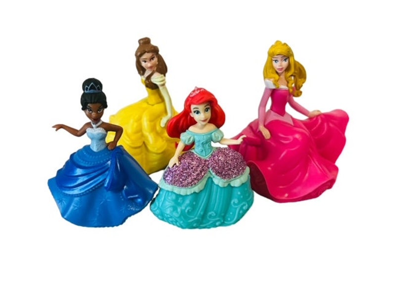 May include: Set of four Disney princess figurines. The princesses are Belle, Aurora, Tiana, and Ariel. Each princess is wearing a colourful dress and has a unique hairstyle.