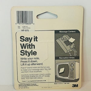 May include: A white and blue package for Post-it brand notes. The package features a phone and a television with a note on each. The text on the package reads "Say it With Style". The package also includes instructions on how to use the notes. The package is made in the USA and is copyright 1990.