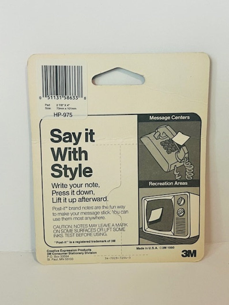 May include: A white and blue package for Post-it brand notes. The package features a phone and a television with a note on each. The text on the package reads "Say it With Style". The package also includes instructions on how to use the notes. The package is made in the USA and is copyright 1990.