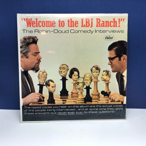 May include: A vintage record album cover featuring a caricature of President Lyndon B. Johnson with the title "Welcome to the LBJ Ranch!" The Robin-Doud Comedy Interviews. The cover features a chessboard with caricature heads of famous people.