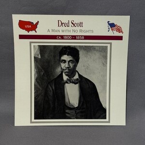 May include: A printed card featuring a black and white portrait of Dred Scott. The card includes the text "Dred Scott A MAN WITH NO RIGHTS CA. 1800 - 1858" along with a USA map and American flag graphic.