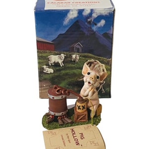May include: A small, white pig figurine with a pink nose and ears, holding a bottle of moonshine. The pig is standing next to a wooden barrel with a metal spout and a fire underneath. The figurine is on a green base with a brown wooden sign that reads "Pig Hollow" by Peter  Haddon. Limited Edition.