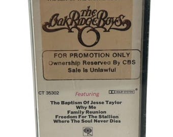 May include: A black cassette tape with a white label featuring The Oak Ridge Boys. The label has the band's name in gold lettering and the text "The Best of The Oak Ridge Boys" and "For Promotion Only Ownership Reserved By CBS Sale Is Unlawful". The cassette tape also features the text "CT 35302", "Featuring", "DO DOLBY SYSTEM", "The Baptism Of Jesse Taylor", "Why Me", "Family Reunion", "Freedom For The Stallion", "Where The Soul Never Dies", and "Columbia Stereo Cassette".