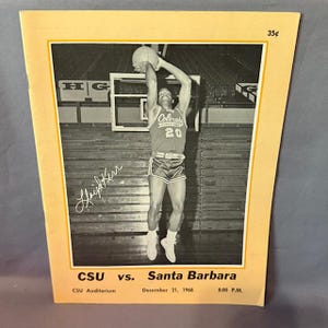 May include: A vintage basketball game program featuring a black and white photo of a player in mid-air, shooting a basketball. The program is for a game between CSU and Santa Barbara, held December 21, 1968, at 8:00 PM. The price is 35¢.