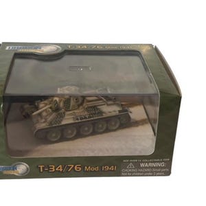 May include: A white and green model of a T-34/76 Mod. 1941 tank in a clear plastic display case. The box is green and has the words "Dragon Models" and "T-34/76 Mod. 1941" on it.