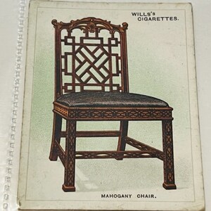 May include: A mahogany chair with a lattice back and a dark brown finish. The chair is featured on a vintage Wills's Cigarettes card.