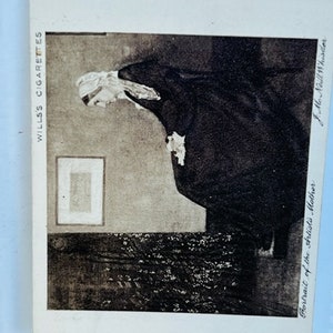 May include: A black and white photo of a woman in a dark dress, with the text "Portrait of the Christ's Mother" and "Wills's Cigarettes" on the card.