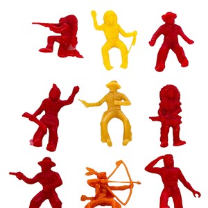 May include: Set of nine plastic toy cowboys and Native Americans. The figures are in red, yellow, and orange. They are all in different poses, some holding weapons, some riding horses, and some standing.