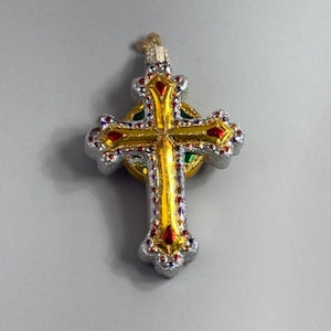 May include: A white ceramic mug with a black handle and the text "But First, Coffee" in a black, handwritten-style font. The mug is on a white surface.