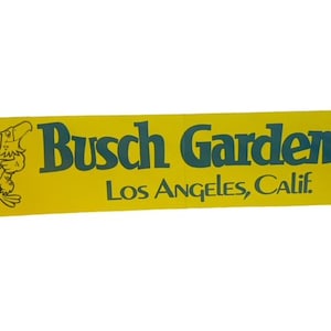 May include: Yellow and green vintage sticker with a cartoon eagle and the text "Busch Gardens Los Angeles, Calif."