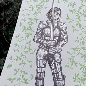 May include: A black and white illustration of a woman in armour holding a sword. The background is a light green with a vine pattern.