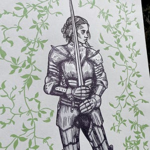 May include: A black and white illustration of a woman in armour holding a sword. The background is a light green with a vine pattern.