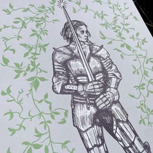 May include: A black and white illustration of a woman in armour holding a sword. The background is a light green with a vine pattern.