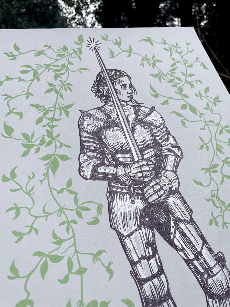 May include: A black and white illustration of a woman in armour holding a sword. The background is a light green with a vine pattern.