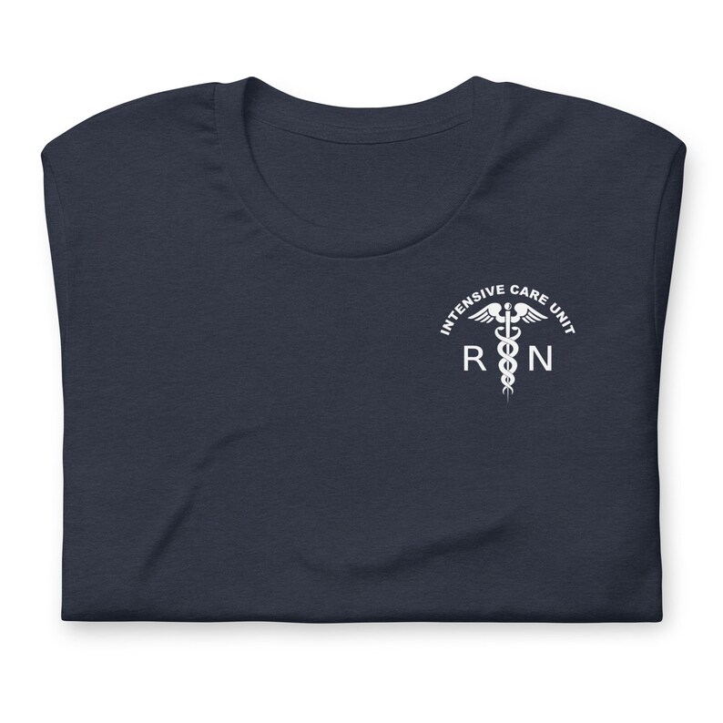 Folded navy blue ICU nurse shirt with white Intensive Care Unit RN chest graphic.