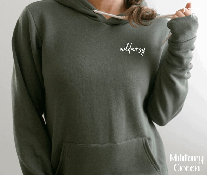 May include: A dark green hooded sweatshirt with the word "outdoorsy" written in white on the front.