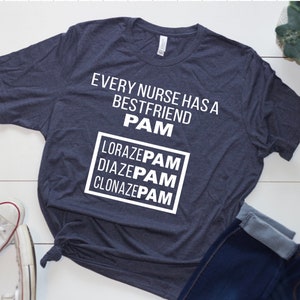 May include: A dark blue t-shirt with white text that reads "Every nurse has a best friend PAM Lorazepam Diazepam Clonazepam".