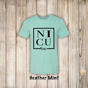 May include: A heather mint t-shirt with a black square graphic that says "NICU Nurse".