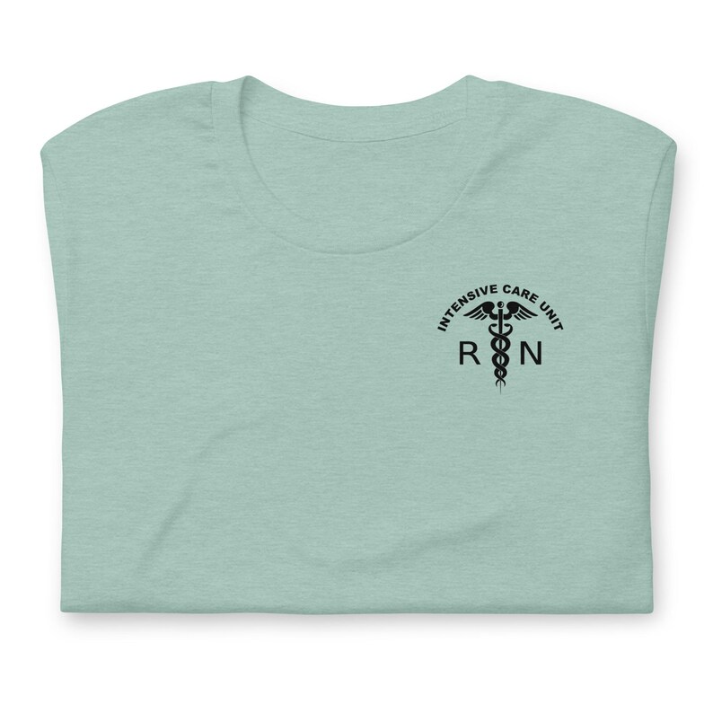 Folded dusty blue ICU nurse shirt with black Intensive Care Unit RN graphic.