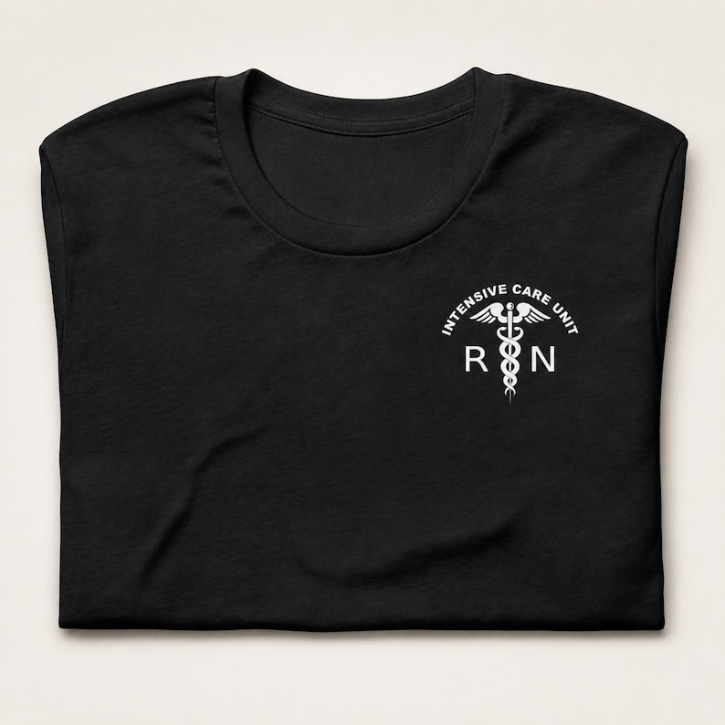 Folded black ICU nurse shirt with white Intensive Care Unit RN left-chest design.