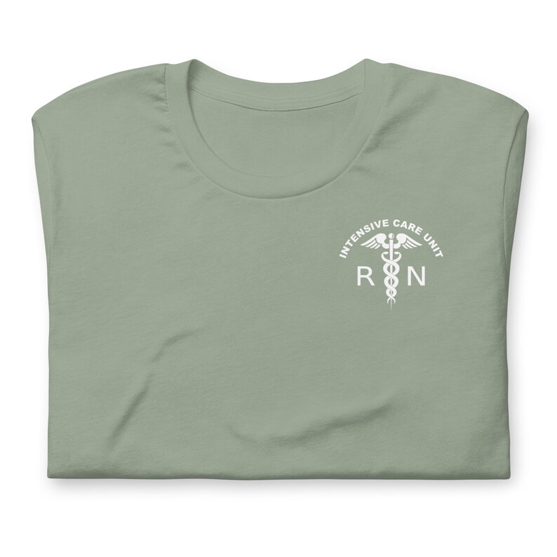 Folded sage green ICU nurse shirt with white critical care RN left-chest print.