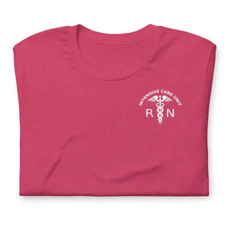 Folded berry pink ICU nurse shirt with white Intensive Care Unit RN chest print.