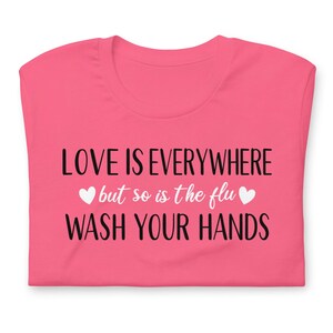 Funny nurse gift shirt love is everywhere design on bright pink RN shirt