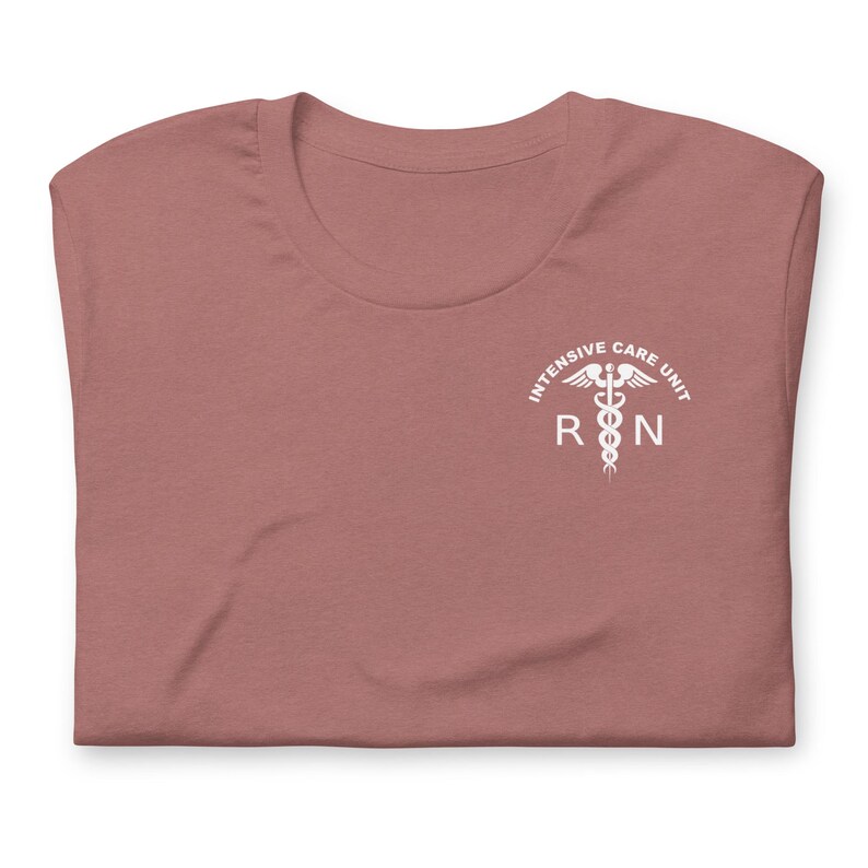 Folded mauve ICU nurse shirt with white Intensive Care Unit RN left-chest print.