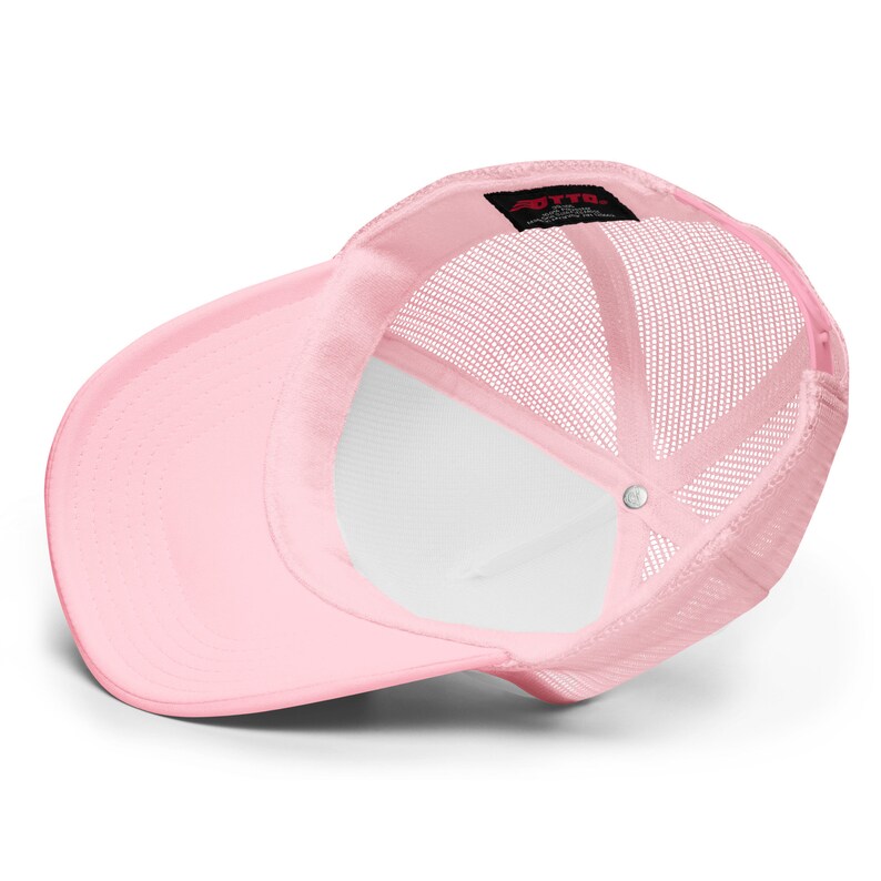 May include: Pink trucker hat with a mesh back. The hat has a small black label with the text "OTTO" on the back.