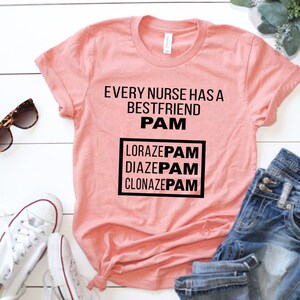 May include: A peach-colored t-shirt with the text "Every nurse has a best friend PAM" and a box with the text "Lorazepam, Diazepam, Clonazepam" in black text.