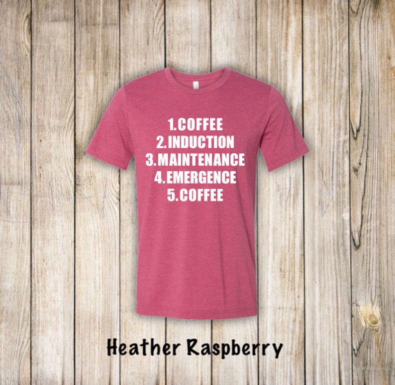 May include: Heather raspberry t-shirt with white text that reads "1. Coffee 2. Induction 3. Maintenance 4. Emergence 5. Coffee"