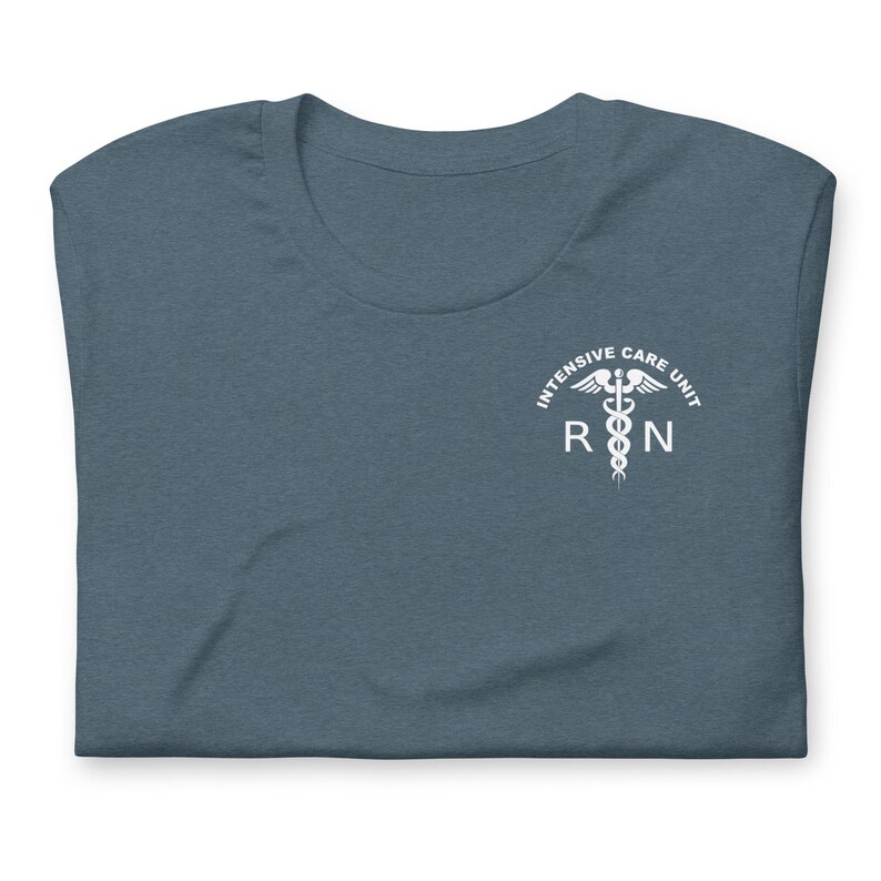Folded heather slate ICU nurse shirt with white Intensive Care Unit RN design.