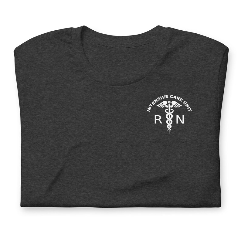 Folded dark gray ICU nurse shirt with white Intensive Care Unit RN design.
