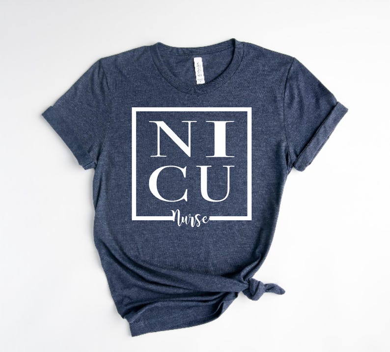 May include: A navy blue t-shirt with a white square graphic that says "NICU Nurse" in a bold font.
