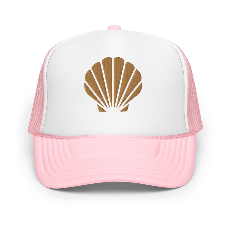 May include: A white and pink trucker hat with a brown seashell design on the front.