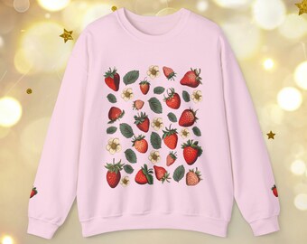May include: A pink sweatshirt with a pattern of red strawberries and white flowers. The strawberries are arranged in a random pattern on the sweatshirt.
