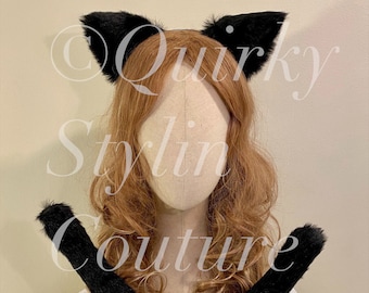 May include: Black cat ears headband and tail set. The headband has two black furry cat ears and the tail is long and fluffy.