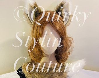 May include: A brown and white faux fur tail and matching ear headband. The headband is on a mannequin head with brown hair. The text "Quirky Stylin Couture" is visible in the background.