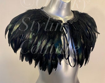 May include: A black feather collar with a black ribbon tie. The collar has a black lace trim and is made of soft feathers.