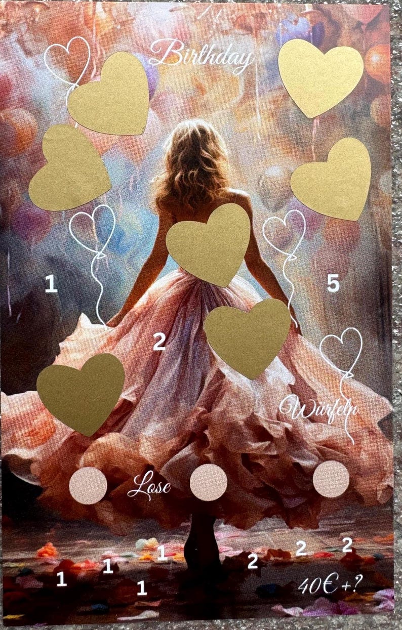 May include: A birthday game with a golden heart design. The game includes a board with hearts and numbers, a dice, and a lose option. The board features a woman in a pink dress with a golden heart on her chest.