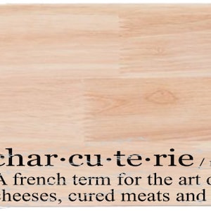 May include: A wooden cutting board with the definition of "charcuterie" written on it. The definition reads: "char-cu-te-rie /noun/ shar koo ter ee A french term for the art of arranging fruit, cheeses, cured meats and other fancy shit."