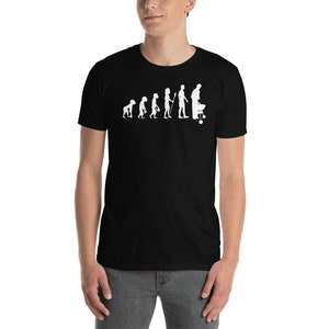 May include: A black t-shirt with a white graphic of the evolution of man, ending with a man grilling. The graphic shows a series of stick figures, starting with a primitive ape and ending with a man standing next to a grill.