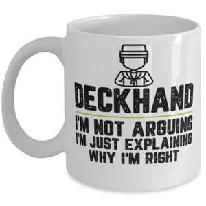 May include: White ceramic coffee mug with a black and white illustration of a sailor with the text "Deckhand I'm not arguing I'm just explaining why I'm right"