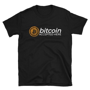 May include: Black t-shirt with a gold bitcoin logo and the text "bitcoin accepted here" in white.