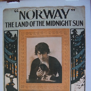 May include: A vintage sheet music cover for the song "Norway, The Land of the Midnight Sun". The cover features a woman holding a small dog, with a snowy forest scene in the background. The text "Successfully Introduced by Kitty Gordon" is printed below the image.