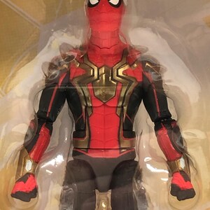 May include: A red and black action figure of Spider-Man wearing a gold and black suit. The figure has a detailed face with a red and black mask.