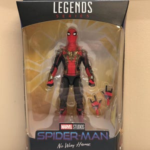 May include: Marvel Legends Series action figure of Spider-Man in his red and black suit with gold accents. The figure is holding a pair of web shooters. The packaging features the title "Spider-Man No Way Home" and the words "Integrated Suit - Costume Combin&eacute; - Spezialanzug - Traje Integrado - Spider-Man".