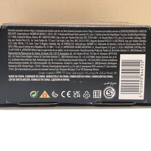 May include: Black cardboard box with a brown top flap. The box has a barcode, text in multiple languages, and several safety and certification logos, including CE, UKCA, and EAC. The text includes the words "Made in China" and "Fabricado en China".