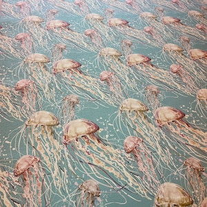 May include: A teal blue background with a repeating pattern of white and pink jellyfish. The jellyfish have long, flowing tentacles.
